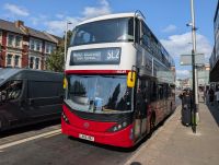 Red and white liveried bus with destination blind that reads SL2 North Woolwich.